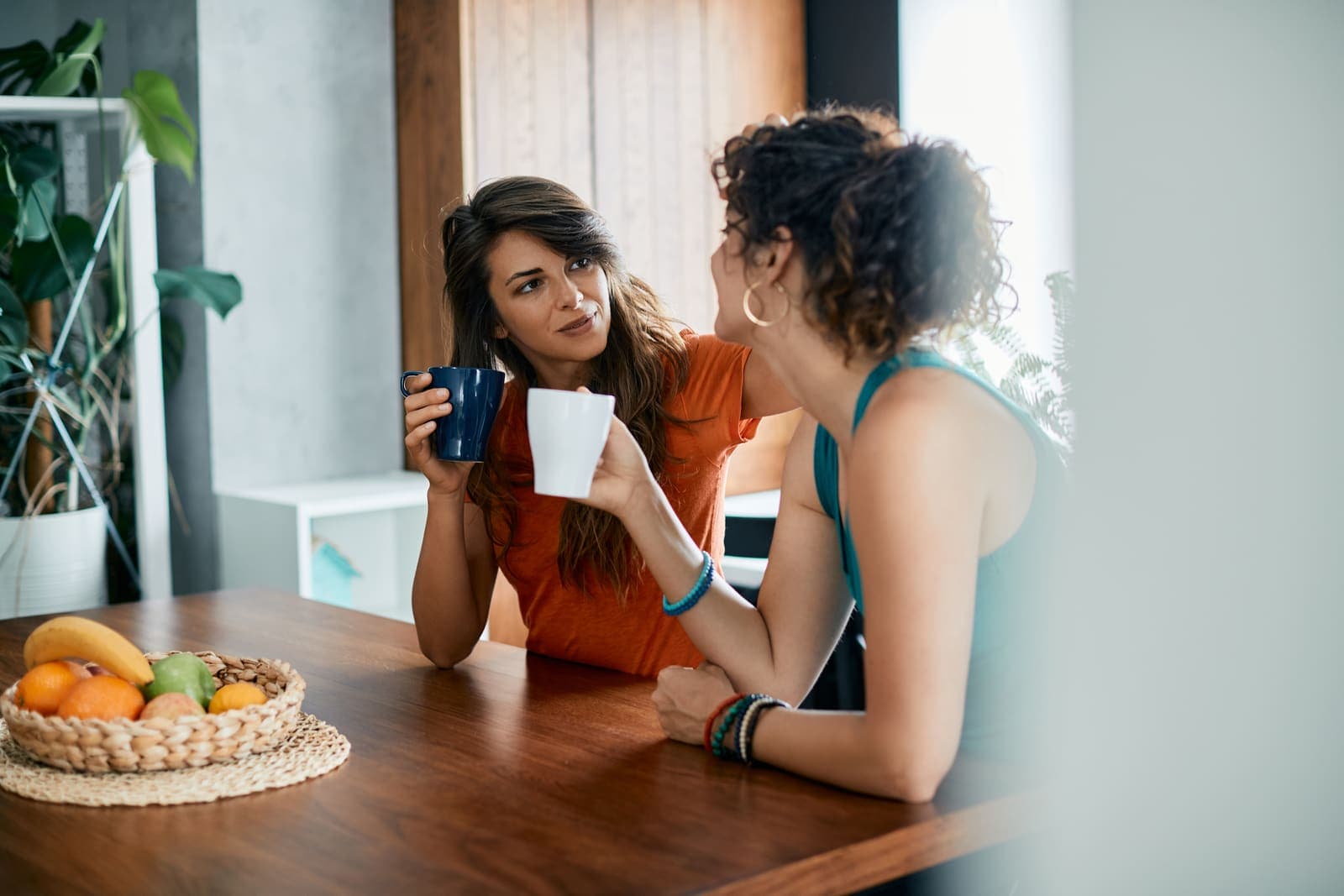 Twee collega's in gesprek met koffie aan tafel